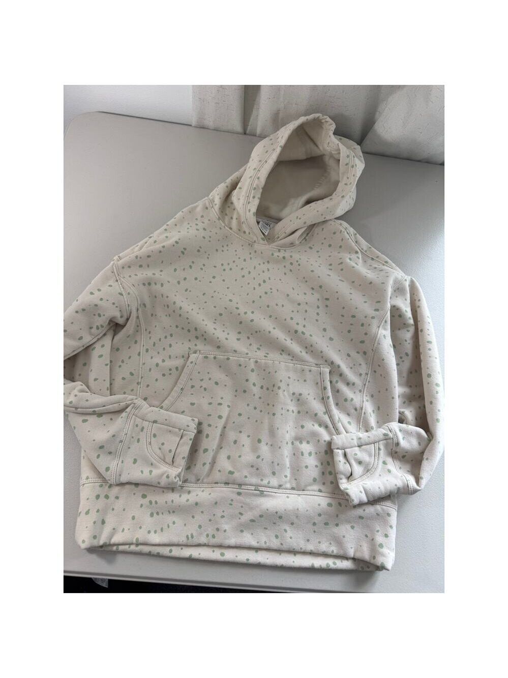 Athleta Girl Retroplush Hoodie in a white and green spotted pattern.
